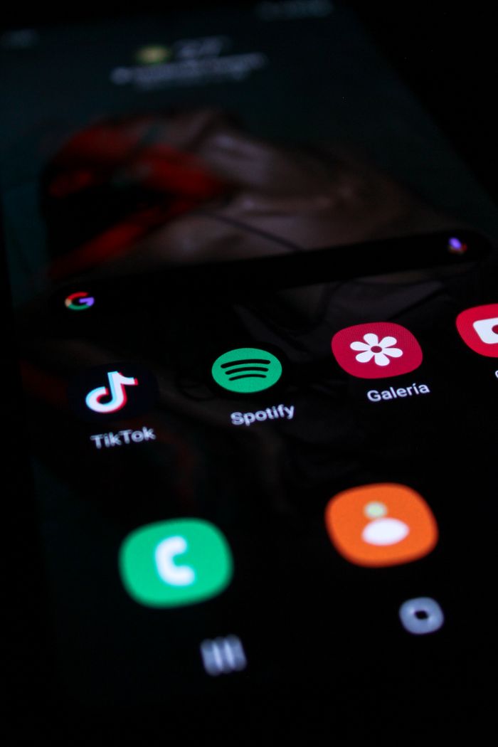 Portrait view of a smartphone display featuring well-known app icons such as TikTok and Spotify.